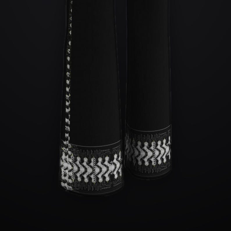 May include: A pair of black trousers featuring a white graphic circuit board pattern along the outer side seams and a horizontal band of the same white digital-style design at the bottom hem of each pant leg against a solid black background.