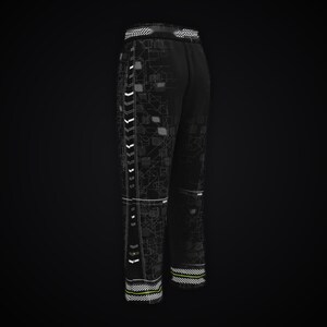 May include: Black sweatpants featuring a white and grey geometric circuit-like pattern across the fabric. The trousers include a vertical side stripe with white chevron accents and horizontal striped detailing at the elasticated waistband and cuffs.