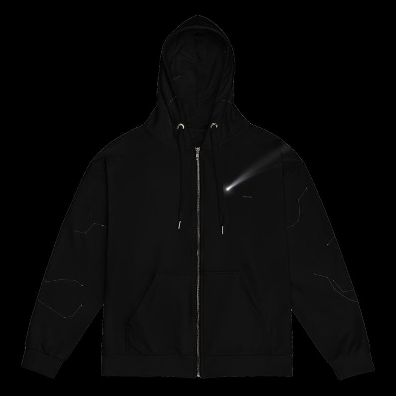 May include: A black zip-up hoodie featuring a silver metal zipper, a drawstring hood, and two front pockets. The chest displays a white graphic of a comet, while the sleeves are decorated with thin, white, linear constellation patterns.