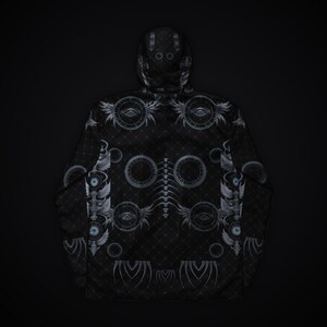 May include: A black hooded jacket featuring a repeating pattern of grey circular eye motifs, winged symbols, and a central spinal column graphic. The fabric has a subtle diamond grid texture throughout the entire garment surface.