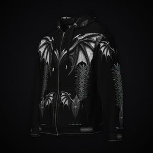 May include: A black zip-up hoodie featuring a white graphic print of large bat-like wings across the chest and shoulders, with intricate vertical spinal patterns running down the front and sleeves, and a drawstring hood with silver aglets.