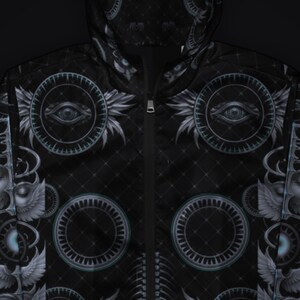 May include: A black zip-up jacket featuring a repeating pattern of winged eyes enclosed in circular frames. The fabric has a subtle diamond grid texture throughout, with a central zipper closure and a hood that continues the graphic design.