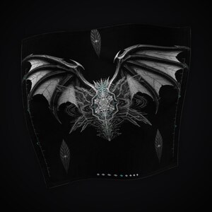 May include: A black fabric square featuring a detailed white graphic of large, spread dragon wings centered above a complex geometric star pattern. Three small, pointed leaf-like shapes are positioned around the central design.