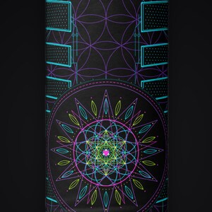 May include: A black rectangular surface featuring a vibrant geometric design. The pattern includes a central circular mandala composed of intersecting lines in neon pink, lime green, and cyan, set against a background of purple overlapping circles.