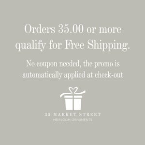May include: White text on a grey background states "Orders &pound;35.00 or more qualify for Free Shipping. No coupon needed, the promo is automatically applied at check-out". A white gift box with a ribbon and heart is below the text. The text "33 MARKET STREET HEIRLOOM ORNAMENTS" is at the bottom of the image.