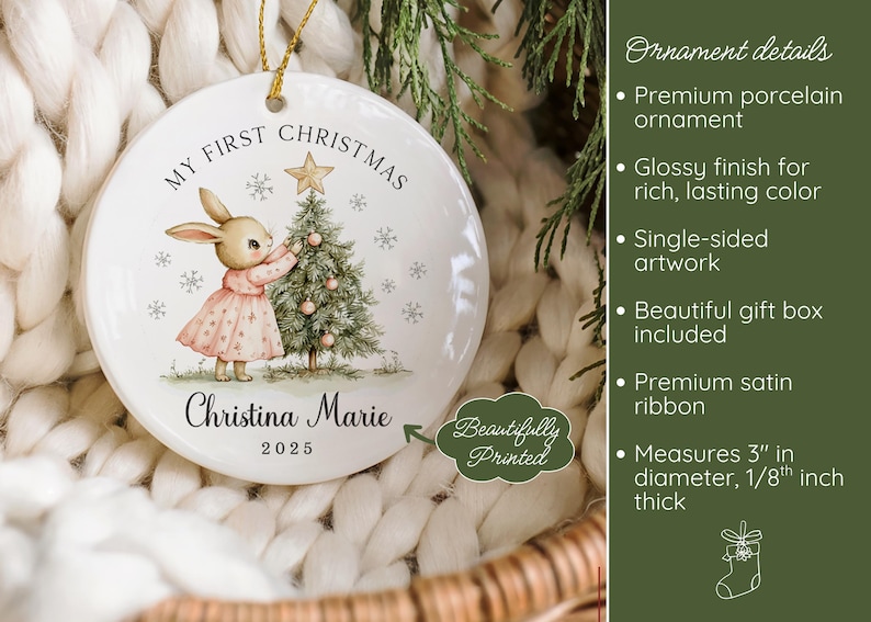 May include: A round white porcelain Christmas ornament measuring 3 inches in diameter and 1/8 inch thick. It features a bunny in a pink dress decorating a tree with the text My First Christmas, Christina Marie, and 2025 printed on the front.