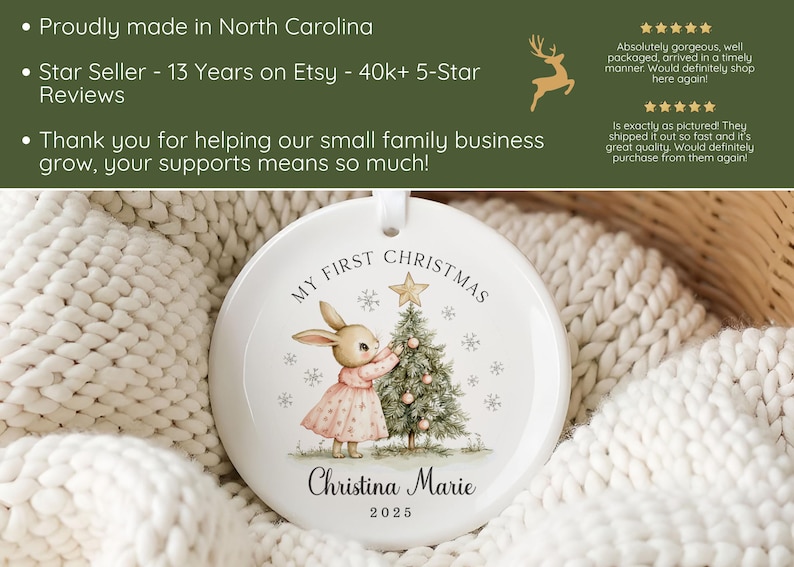 May include: A round white ceramic ornament featuring a printed illustration of a rabbit in a pink dress decorating a Christmas tree. The text reads My First Christmas, Christina Marie, and 2025. The ornament has a small hole at the top for hanging.