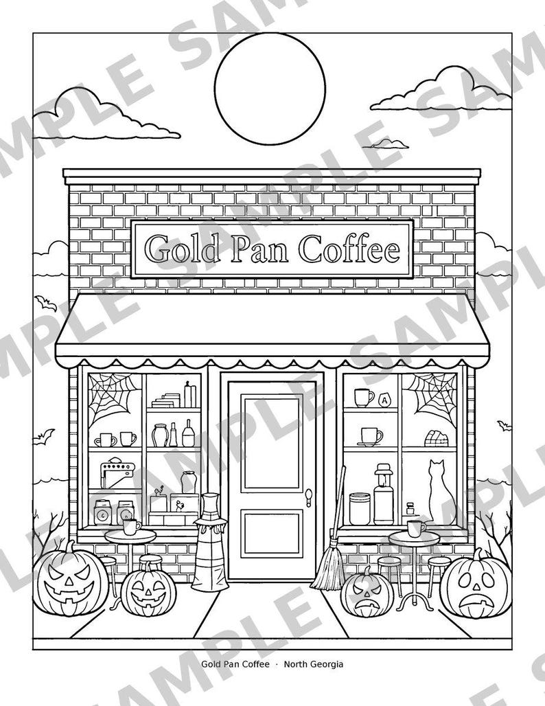 May include: A black and white coloring page featuring a storefront labeled Gold Pan Coffee. The scene includes a brick building, large display windows with spiderwebs, a central door, two small tables with mugs, and four jack-o'-lanterns.