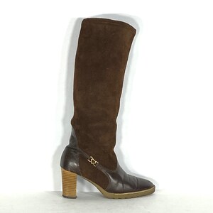 May include: Brown suede knee-high boots with a leather lower section and a wooden heel.