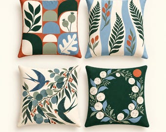 May include: A set of four square throw pillows featuring diverse botanical and avian illustrations. Designs include geometric shapes with leaves, fern fronds with orange buds, two blue swallows among leafy branches, and a circular wreath on dark green.