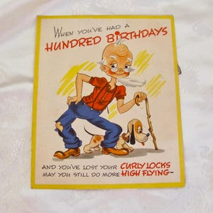 May include: Vintage birthday card with a cartoon illustration of an elderly man with a long white beard, glasses, and a cane, accompanied by a dog. The card has yellow borders and text that reads "When you've had a hundred birthdays..."