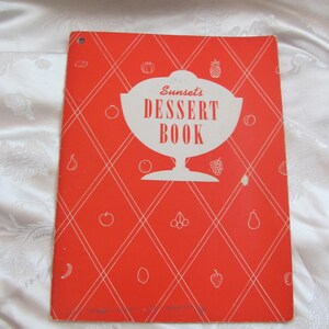 May include: A red cookbook with a white diamond pattern and the text "Sunset's Dessert Book" in a white bowl graphic.