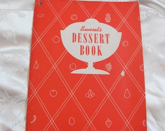 May include: A red cookbook with a white diamond pattern and the text "Sunset's Dessert Book" in a white bowl graphic.