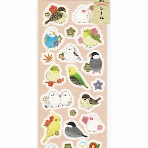 May include: A sheet of stickers featuring various colourful birds, including a blue and green parakeet, a yellow canary, and a white dove. The stickers are on a peach background with gold accents and Japanese text that reads "Japanese New Year Stickers".