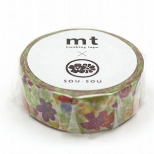 Könnte beinhalten: Eine Rolle Masking Tape mit einem Blumenmuster in Grün-, Lila-, Rot- und Gelbtönen. Das Klebeband ist in klarem Kunststoff verpackt. Auf dem Etikett steht "mt masking tape" mit einem Blumenlogo und dem Wort "SOU SOU".