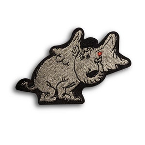 May include: Embroidered patch depicting a cartoon creature with large ears and a red eye. The patch is grey with black edging, and the design is detailed with textured stitching. The creature is in a seated position.