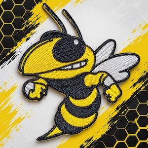 May include: An embroidered patch featuring a cartoon hornet with a yellow and black striped body, large dark eyes, and white wings. The hornet is depicted in a dynamic pose with its arms raised, showcasing detailed stitching and bold colors.