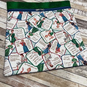 May include: A quilted fabric project bag with a green top and a zipper closure. The bag features a repeating pattern of vintage-style illustrations of women in dresses with text bubbles. The text includes the words "Needlework" and "Procrastibake".