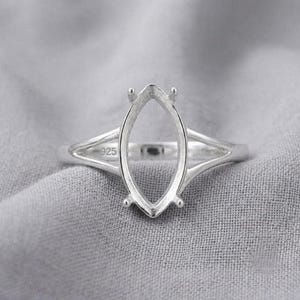 May include: A sterling silver ring setting featuring a marquise-shaped prong mount for a gemstone. The band is split into two thin arms that connect to the central setting. The inner band is clearly stamped with the hallmark 925.