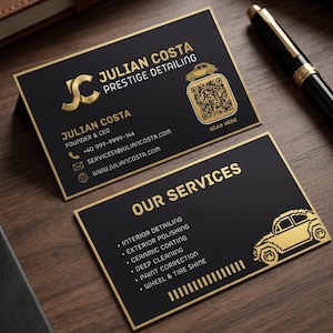 May include: Two black business cards with gold text and accents. One card displays the name Julian Costa, Prestige Detailing, contact info, and a QR code. The second card lists services including interior detailing, exterior polishing, ceramic coating, deep cleaning, paint correction, and wheel and tyre shine.