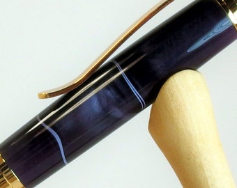 Purple swirl pen in bright gold setting