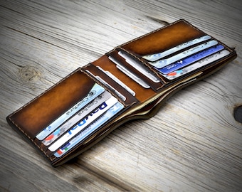May include: A brown leather wallet with multiple card slots and a billfold. The wallet is open and several credit cards are visible.