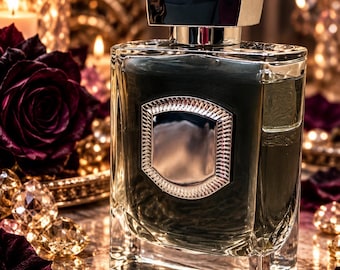 May include: A rectangular glass perfume bottle with a dark liquid inside, featuring a metallic silver shield-shaped emblem on the front and a thick, polished silver cap with a textured top surface. The bottle has clear, thick glass walls.