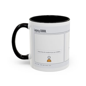 May include: A white ceramic mug with a black interior and handle, featuring a comic strip graphic titled Legacy COBOL. The panel shows a speech bubble with the text Have the AI modernize our COBOL above a simple orange and black icon.