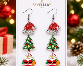 May include: A pair of dangle earrings on a white display card labeled ZEVELLERY. Each earring features three stacked charms: a red glitter Santa hat, a green glitter Christmas tree with yellow and red ornaments, and a Santa Claus figure.