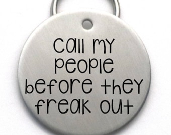 May include: Silver dog tag with the text "Call my people before they freak out".