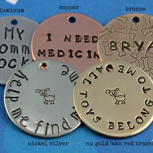 May include: Five round metal dog tags in different colors and finishes. The tags are engraved with various messages, including "My Mom Rocks", "I Need Medicine", "All Toys Belong To Me", and "Help Me Find My All Toys". The tags are also decorated with a small dog illustration and bone shapes.