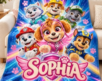 May include: A blue fleece blanket featuring the Paw Patrol characters Everest, Rubble, Rocky, Marshall, Skye, and Chase. The name Sophia is printed in large pink letters at the bottom, accented by pink paw prints and a shield emblem.
