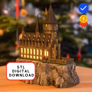 May include: A 3D printed model of a castle with multiple towers and illuminated windows, set on a rocky base. The model features dark gray walls and a text box that reads STL DIGITAL DOWNLOAD in black letters on a white background.