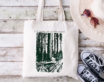 May include: A white tote bag with a green forest illustration and the text "I'd rather be in the forest".