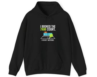 May include: A black hooded sweatshirt featuring a graphic print with the text I BOOKED THE 7AM COURT. I REGRET NOTHING. The design includes a stylised tennis court, a rising sun, and a lime green tennis racket on the front centre.