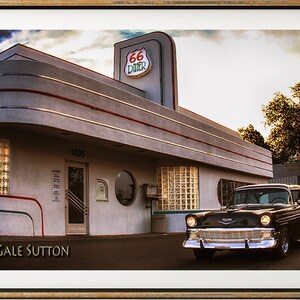 May include: A black classic car parked in front of a retro diner with a "Route 66 Diner" sign. The diner has a white and gray exterior with red and green accents. The car is a 1950s Chevrolet Bel Air.