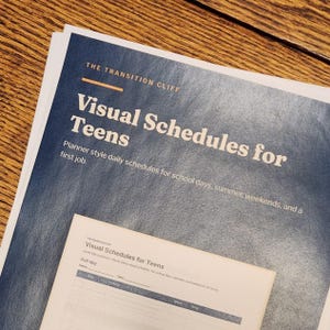 May include: A printed document titled The Transition Cliff Visual Schedules for Teens, featuring a dark blue textured background with white text and a smaller, light-colored planner page template showing fields for name, date, time, activity, and done.