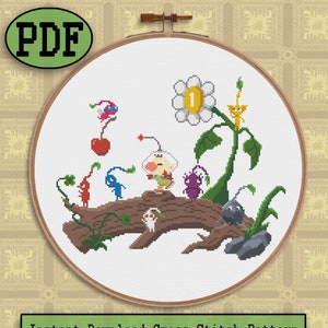 May include: Cross stitch pattern featuring a group of pixelated characters from the video game 'Kirby's Dream Land'. The characters are standing on a log with a flower and a cherry in the background. The pattern is in a white hoop.