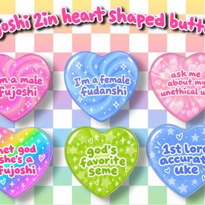 May include: Six heart-shaped buttons with a pastel checkered background. Text reads: Fujoshi 2in heart shaped buttons, I'm a male fujoshi, I'm a female fudanshi, ask me about my unethical uke, met god she's a fujoshi, god's favorite seme, 1st lore accurate uke.