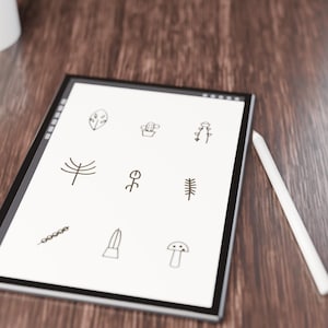 May include: A digital tablet with a white screen displaying nine black line-art icons of plants and nature elements, including a leaf, cactus, flower, tree, and mushroom, accompanied by a white stylus resting on the side.