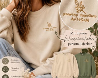 Puede incluir: Una sudadera de cuello redondo color arena con un diseño de rama botánica bordado en el pecho izquierdo. Debajo de la rama, el texto dice "growing together" seguido de las iniciales "A+T+S+M" en hilo marrón.