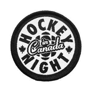 May include: Black and white embroidered patch with the text "Hockey Night in Canada" in a circle. The patch has a black border and a white background.