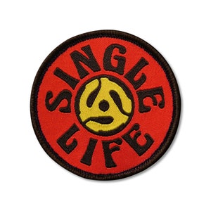 May include: Red and black embroidered patch with a yellow record design and the text "Single Life".