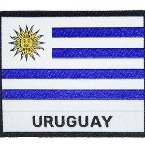 Peut inclure: Patch brodé représentant le drapeau de l'Uruguay. Le drapeau est blanc avec un soleil bleu dans le coin supérieur gauche et neuf bandes bleues horizontales.