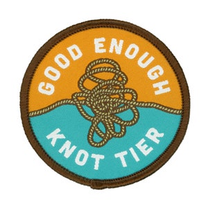 May include: A round patch in brown and orange with the text "Good Enough Knot Tier" and a brown rope tied in a knot.