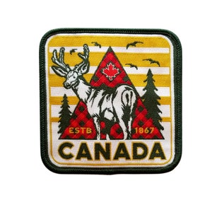May include: An embroidered patch featuring a white deer silhouette, a red maple leaf, and the text "ESTB 1867 CANADA". The patch is green, yellow and red.