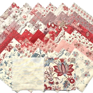 May include: A collection of fabric squares in various floral patterns and colors, including red, pink, and cream. The fabric pieces are arranged in a zig-zag pattern, showcasing a variety of designs, from delicate flowers to bold, stylized blooms.