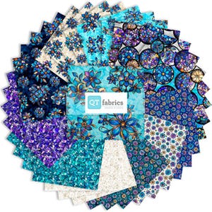 May include: A collection of fabric squares in various shades of blue, teal, and purple, featuring floral and abstract patterns. The fabric squares are arranged in a circular pattern, with a central label that reads "QT fabrics".
