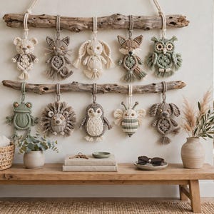 May include: A wall hanging featuring two horizontal pieces of driftwood, each suspending five macrame animal figures. The figures include a bear, cat, rabbit, fox, owl, frog, hedgehog, penguin, bee, and dog, all crafted from neutral-toned cord.