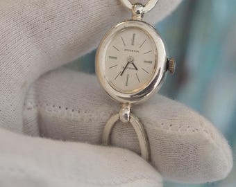 Vintage Dugena Ladies Bracelet Watch Silver Tone Oval Dial Minimalist Wristwatch Elegant Retro Jewelry